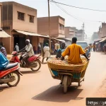 부르키나파소의 특이한 교통 문화 - A bustling street scene in Ouagadougou, Burkina Faso, showcasing a vibrant mix of transportation mod...